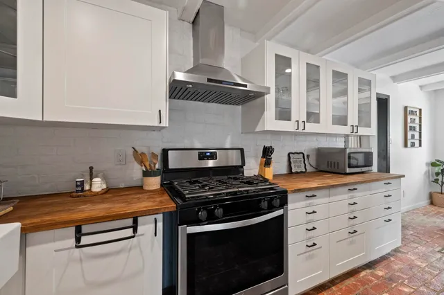 a kitchen with granite countertop a stove and a sink
