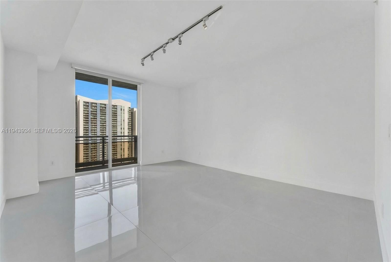 901 Brickell Key Boulevard, Unit 3206 Miami, FL 33131 - Photo 13 of 41 an empty room with windows