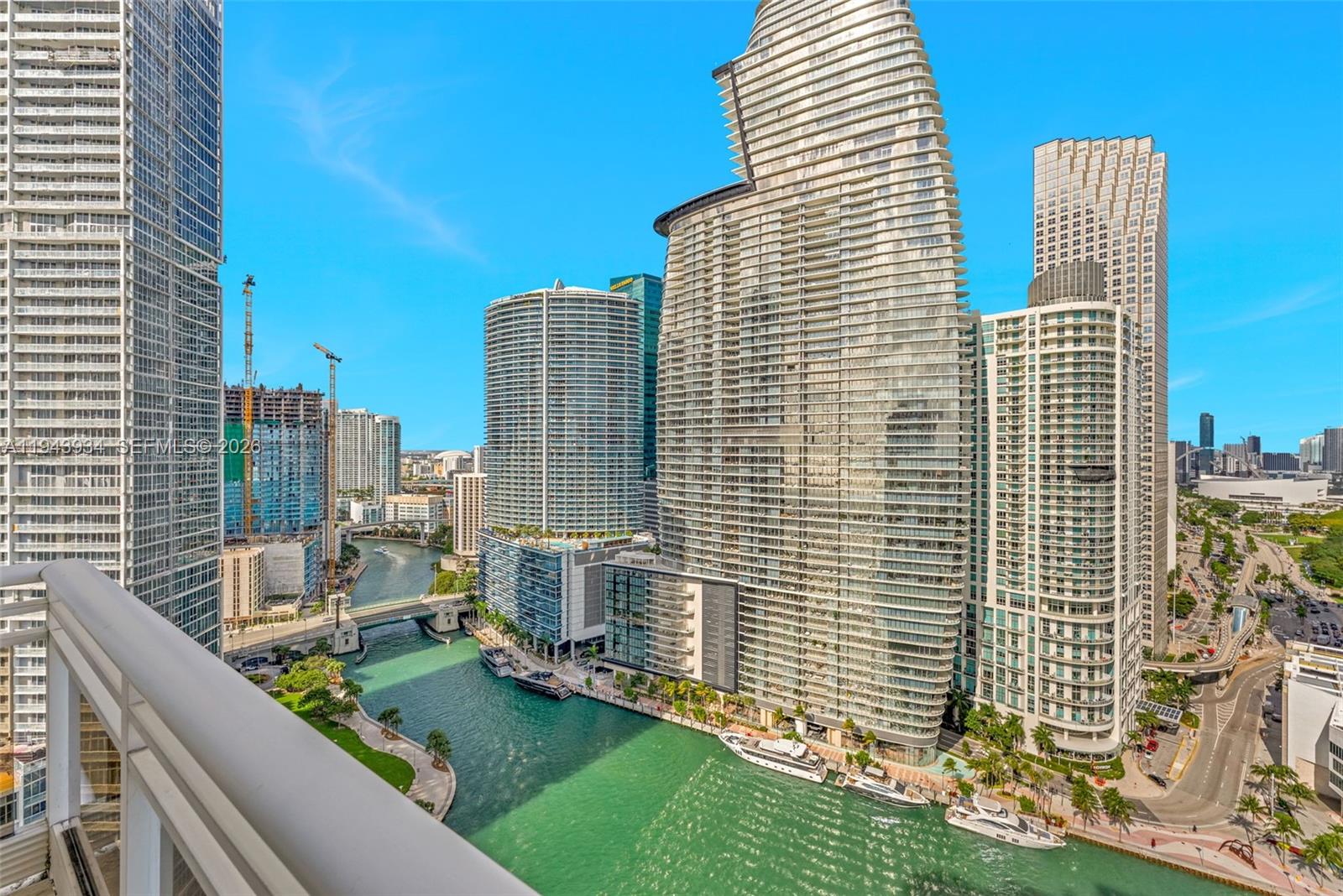 901 Brickell Key Boulevard, Unit 3206 Miami, FL 33131 - Photo 16 of 41 a view of balcony with a couple of cars parked in front of door