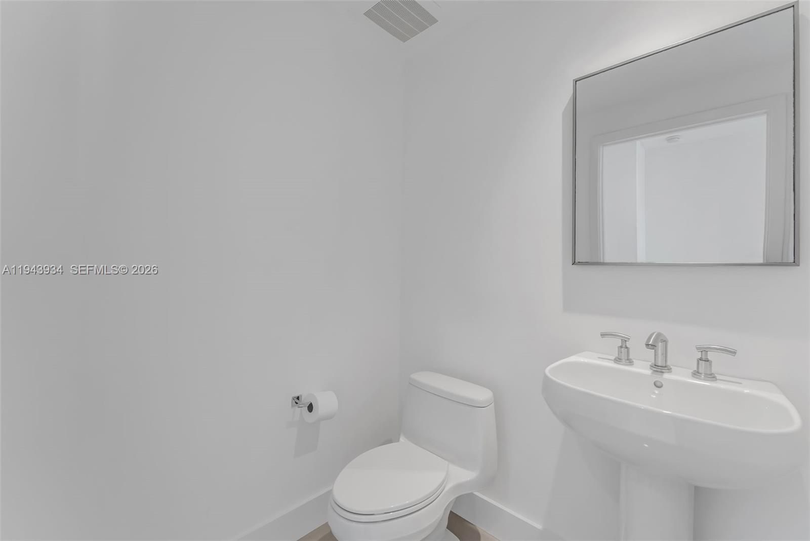 901 Brickell Key Boulevard, Unit 3206 Miami, FL 33131 - Photo 30 of 41 a white toilet sitting next to a bathroom sink