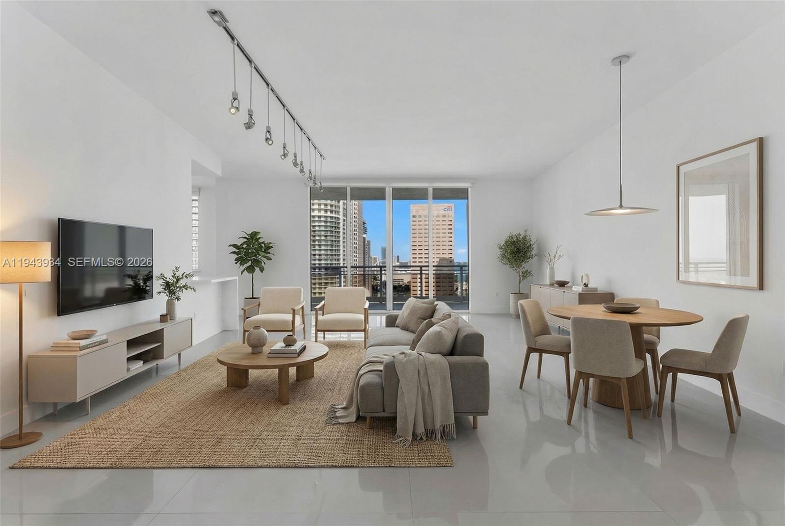 901 Brickell Key Boulevard, Unit 3206 Miami, FL 33131 - Photo 5 of 41 a living room with furniture and a flat screen tv