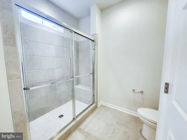 a bathroom with a shower and toilet