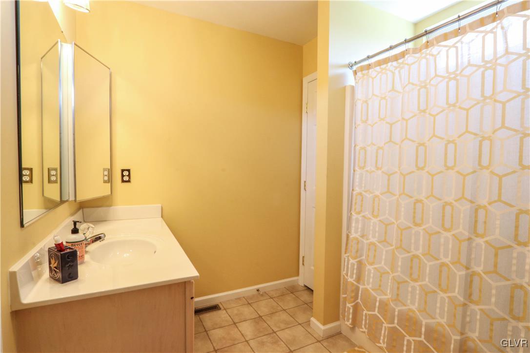 136 Starr Road Reading, PA 19608 - Photo 16 of 45 a bathroom with a sink a mirror and shower