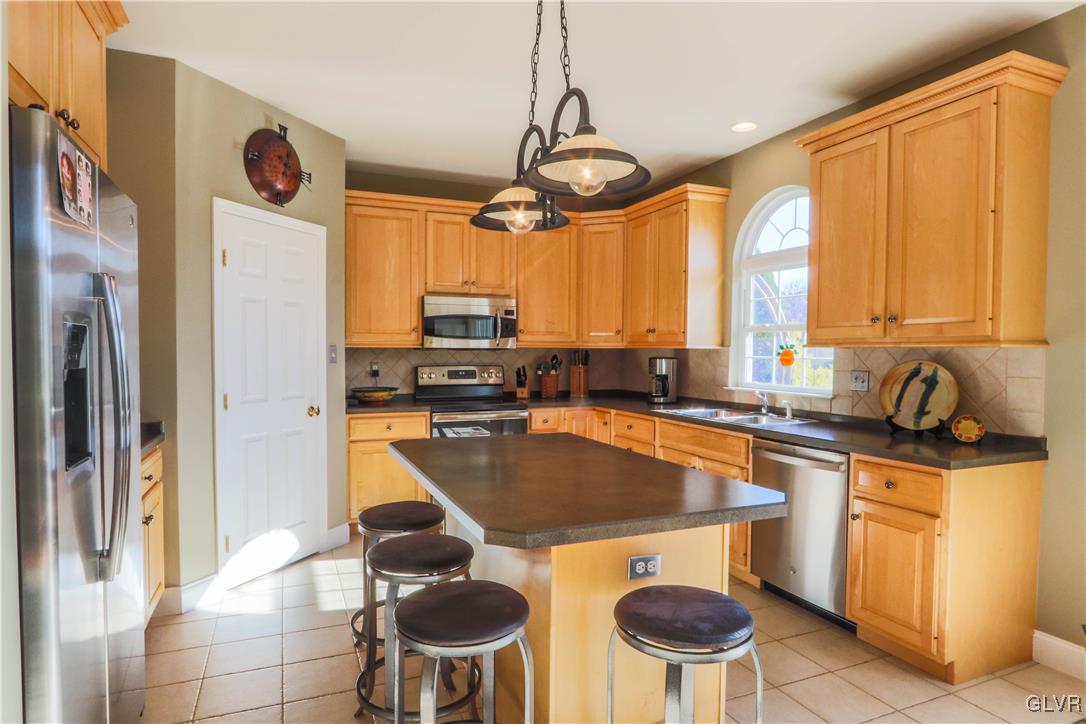 136 Starr Road Reading, PA 19608 - Photo 9 of 45 a kitchen with stainless steel appliances a stove a refrigerator and cabinets