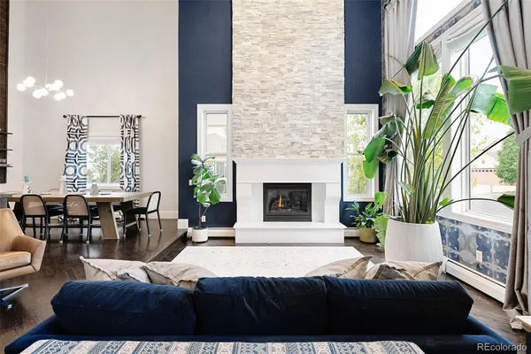 a kitchen with stainless steel appliances granite countertop a kitchen island a stove a sink a dining table and chairs