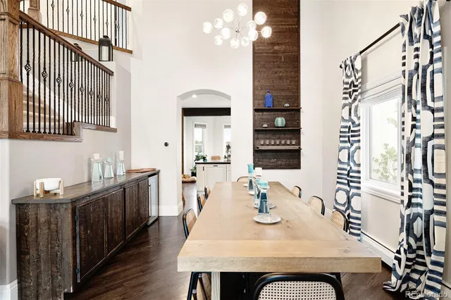 a spacious bedroom with a bed a chandelier and a window