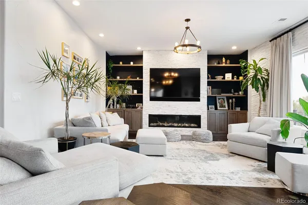 a large kitchen with stainless steel appliances a large counter top a stove and a refrigerator