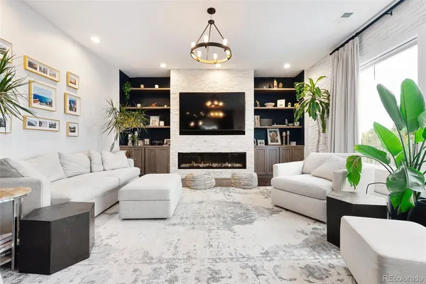a living room with furniture and a potted plant