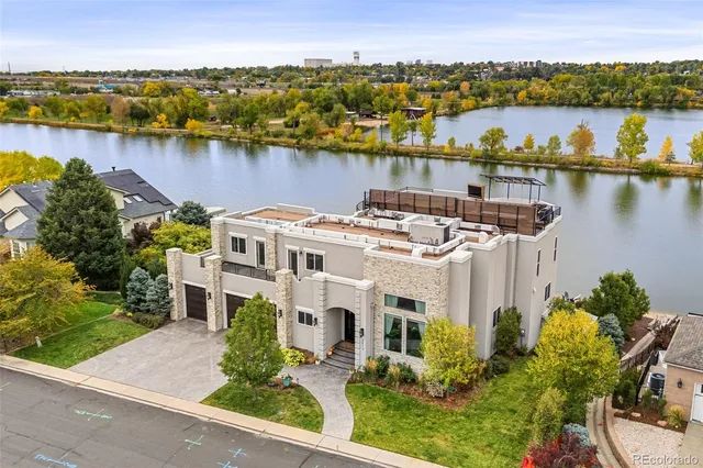 a living room with furniture fireplace and potted plants