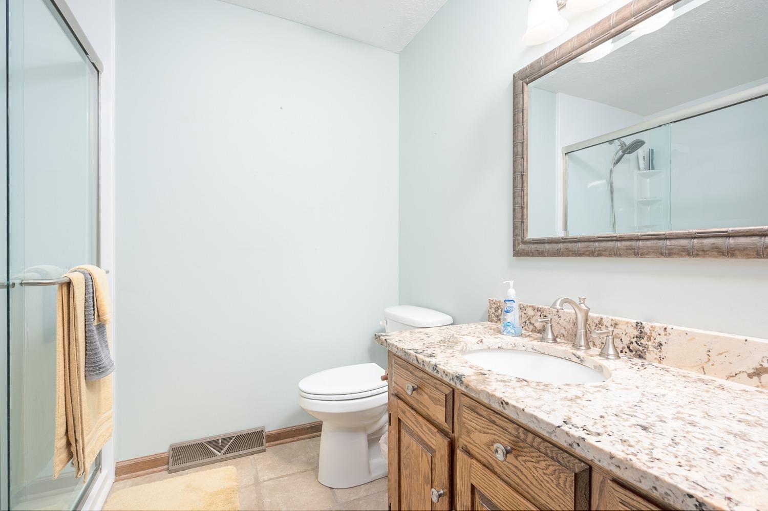 136 Guffey Terrace Lynchburg, VA 24502 - Photo 16 of 33 a bathroom with a granite countertop sink and a toilet