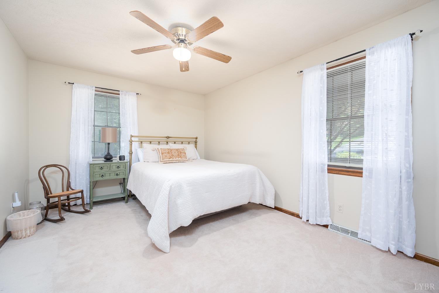 136 Guffey Terrace Lynchburg, VA 24502 - Photo 20 of 33 a bedroom with a bed next to a window with a chandelier