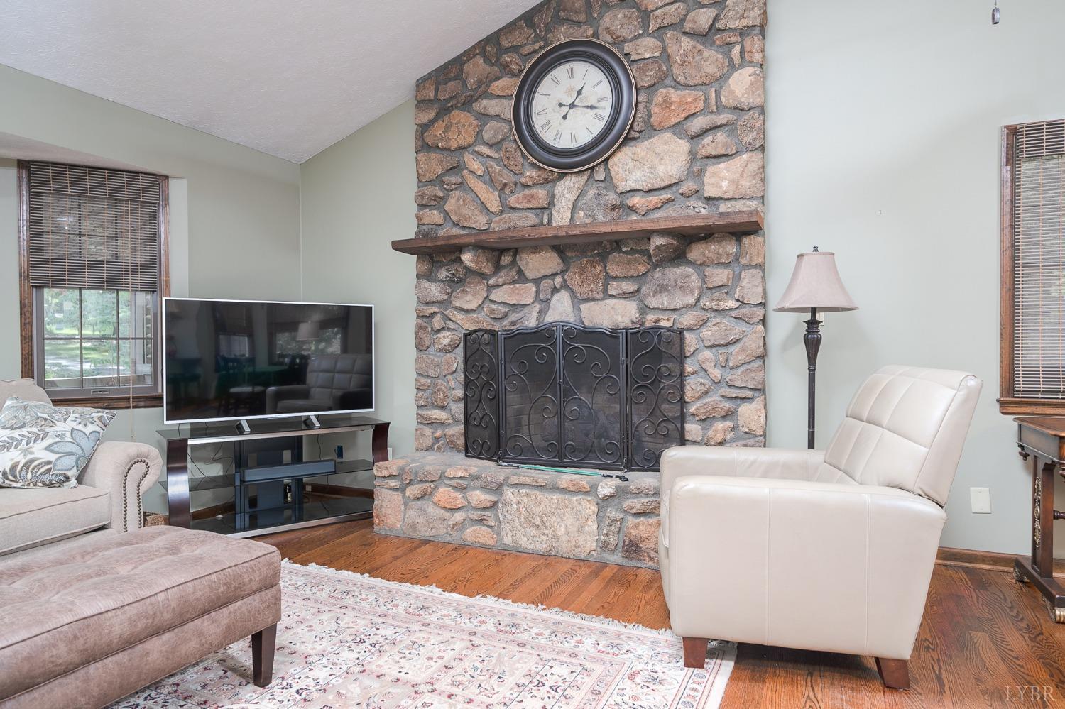 136 Guffey Terrace Lynchburg, VA 24502 - Photo 9 of 33 a living room with furniture a flat screen tv and a fireplace with a bookshelf