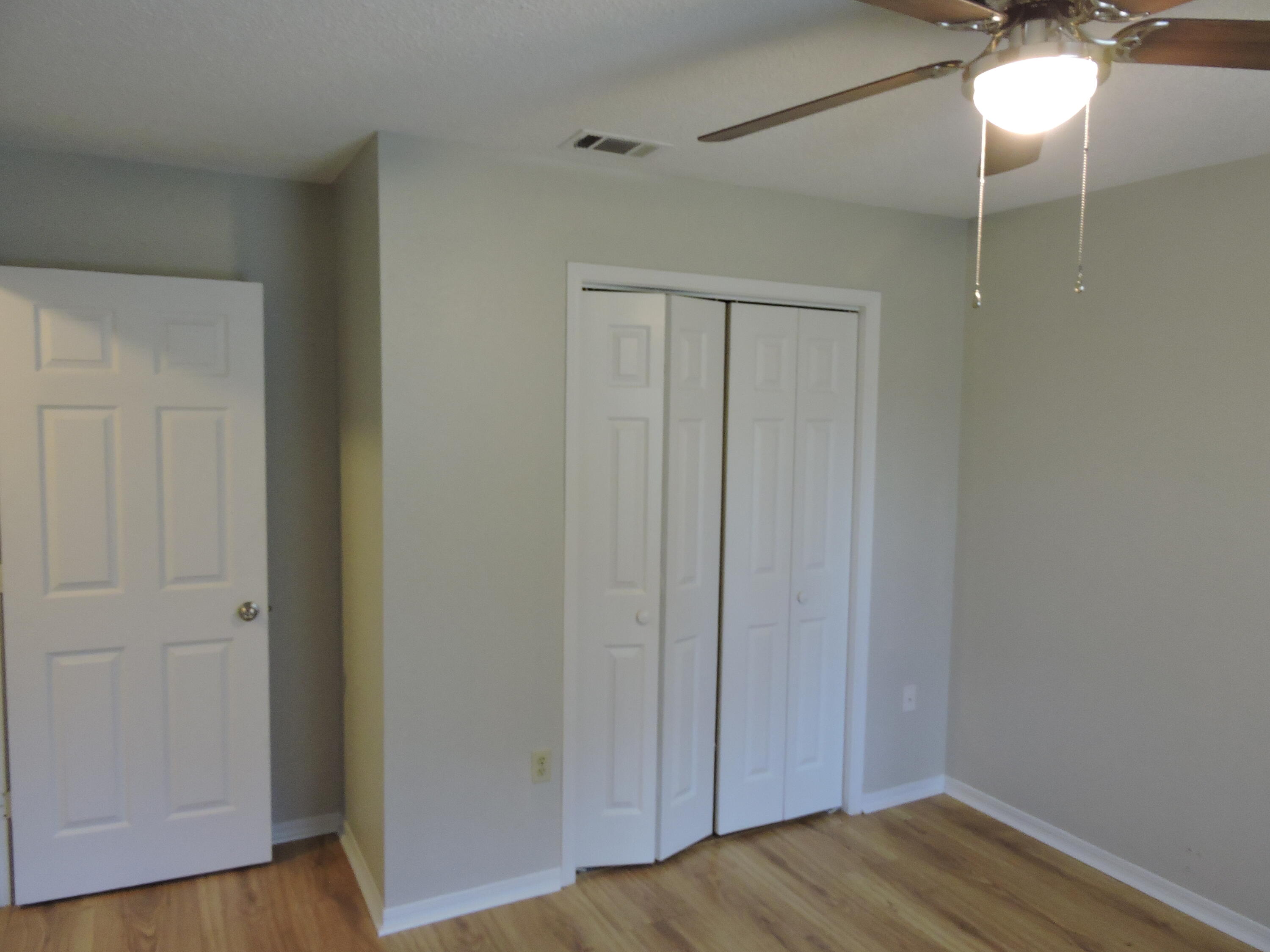 813 Valley Road Crestview, FL 32539 - Photo 16 of 18 a view of an empty room with wooden floor