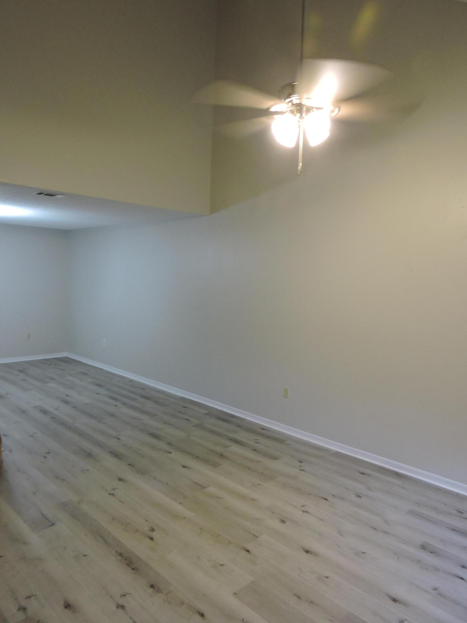 813 Valley Road Crestview, FL 32539 - Photo 2 of 18 a view of an empty room and wooden floor