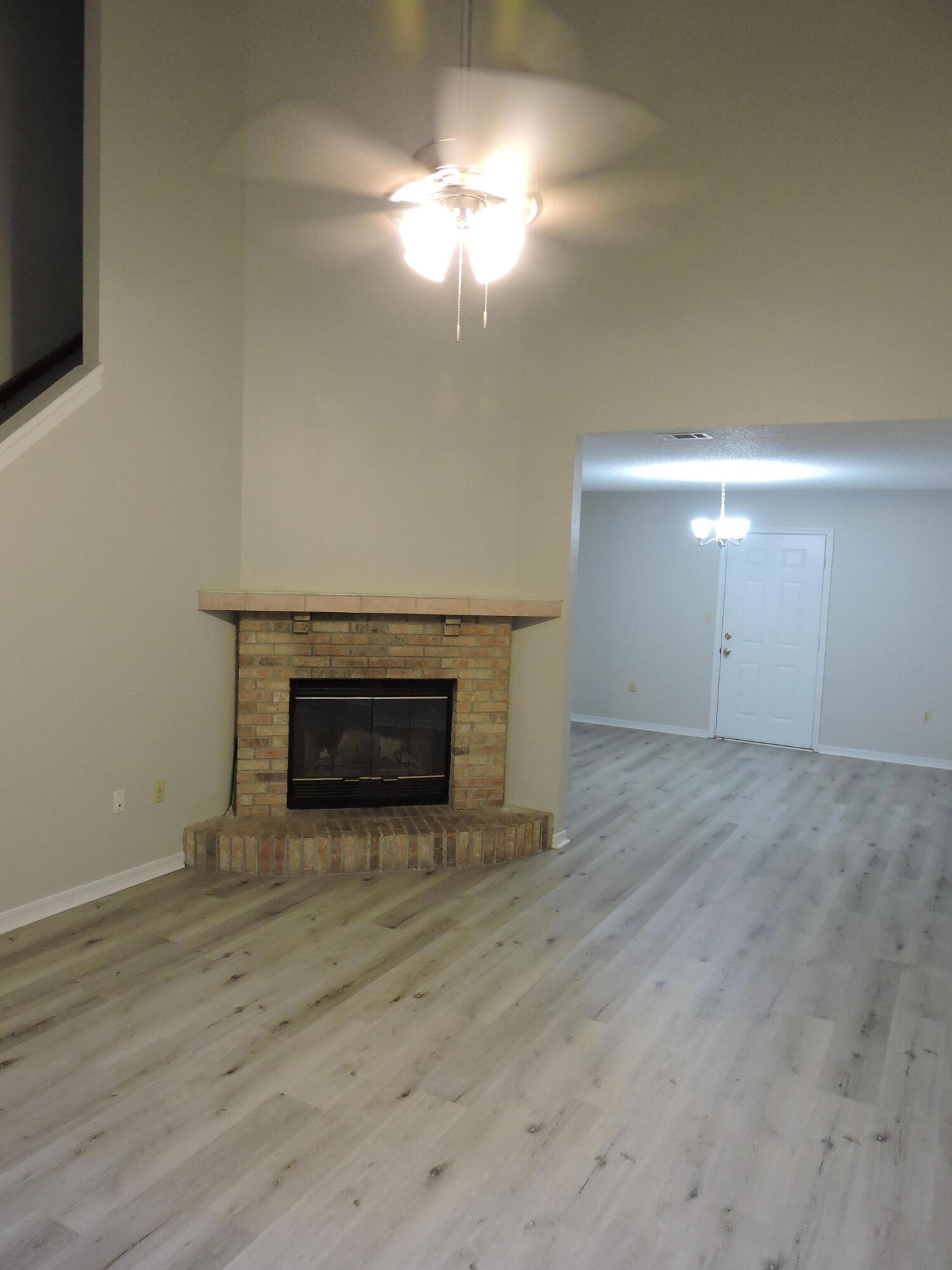 813 Valley Road Crestview, FL 32539 - Photo 4 of 18 a view of empty room with wooden floor and fireplace