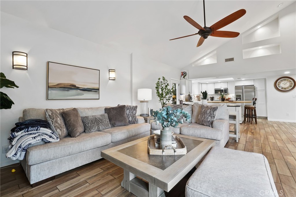 11731 Wembley Road Rossmoor, CA 90720 - Photo 13 of 51 a living room with furniture potted plant and window