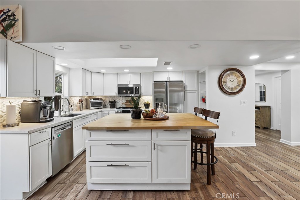 11731 Wembley Road Rossmoor, CA 90720 - Photo 15 of 51 a kitchen with a sink appliances and cabinets