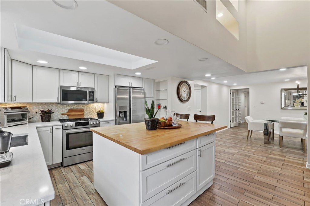 11731 Wembley Road Rossmoor, CA 90720 - Photo 17 of 51 a kitchen with a sink stove and refrigerator