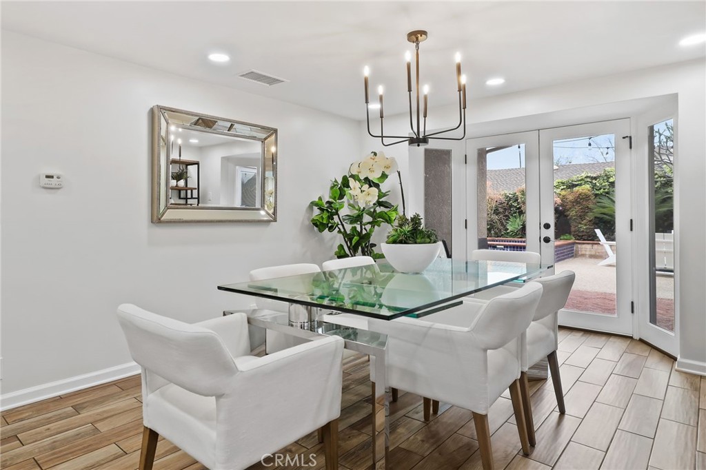 11731 Wembley Road Rossmoor, CA 90720 - Photo 19 of 51 a dining room with furniture a chandelier and window