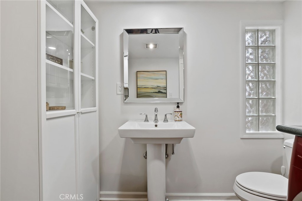 11731 Wembley Road Rossmoor, CA 90720 - Photo 22 of 51 a bathroom with a toilet sink and mirror