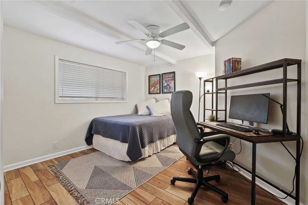 11731 Wembley Road Rossmoor, CA 90720 - Photo 29 of 51 a bedroom with a bed a chair and potted plant on the table