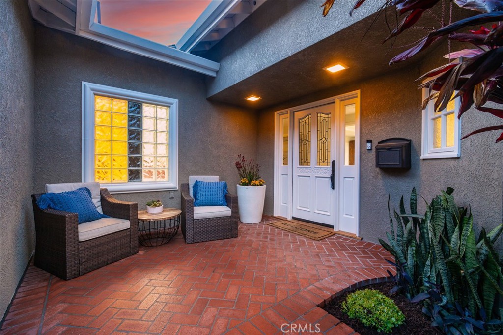 11731 Wembley Road Rossmoor, CA 90720 - Photo 3 of 51 a bedroom with furniture and a potted plant