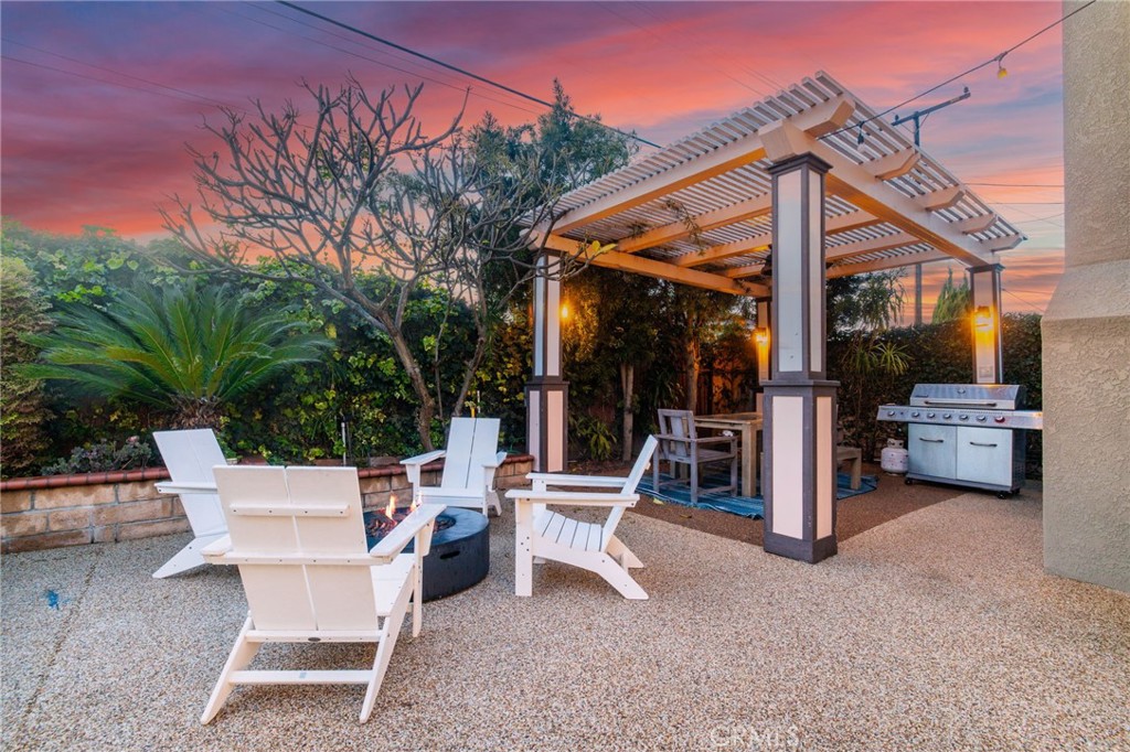 11731 Wembley Road Rossmoor, CA 90720 - Photo 41 of 51 a view of a patio with a table and chairs under an umbrella
