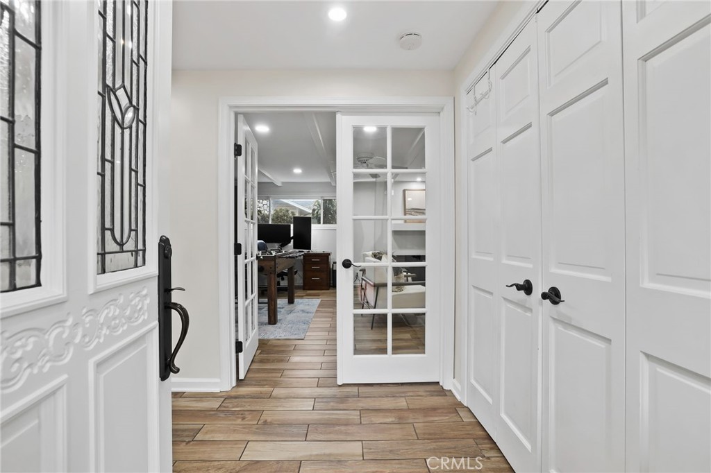 11731 Wembley Road Rossmoor, CA 90720 - Photo 5 of 51 a view of a hallway with wooden floor and staircase