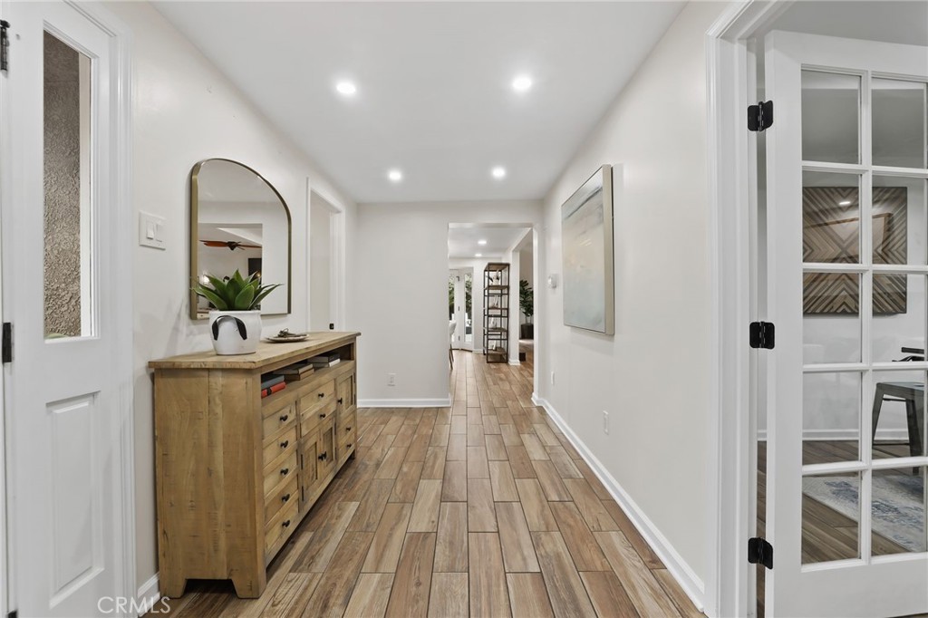 11731 Wembley Road Rossmoor, CA 90720 - Photo 6 of 51 a view of a hallway view with wooden floor and staircase