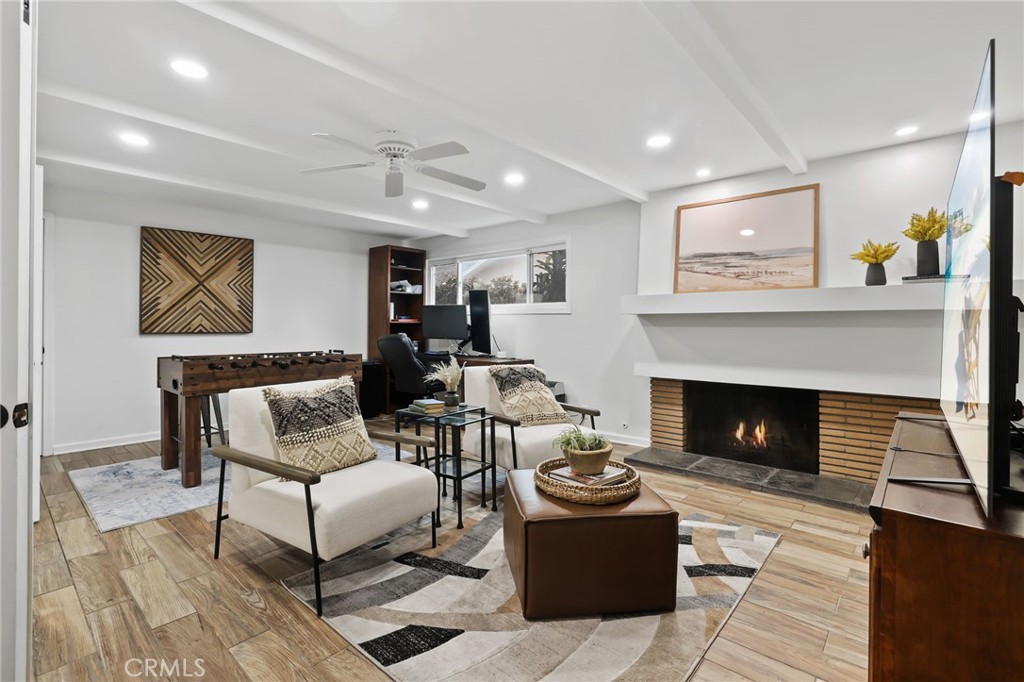 11731 Wembley Road Rossmoor, CA 90720 - Photo 8 of 51 a living room with furniture and a fireplace