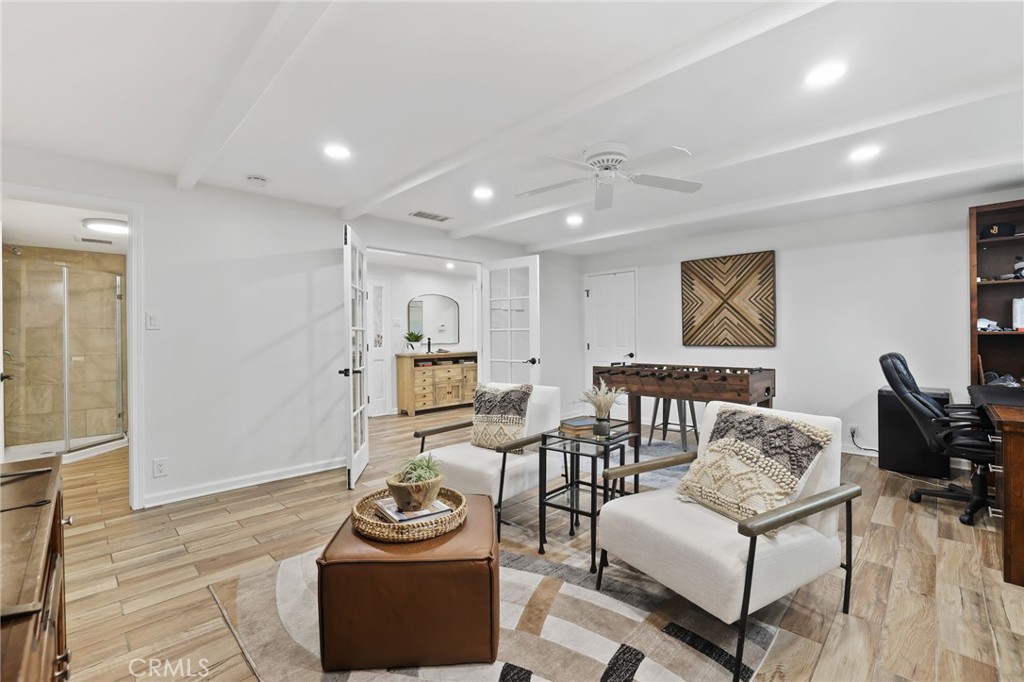 11731 Wembley Road Rossmoor, CA 90720 - Photo 9 of 51 a living room with furniture and a flat screen tv