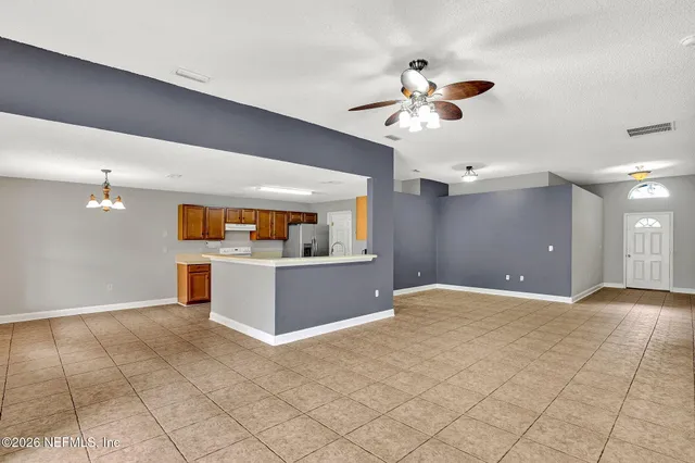 a view of a kitchen with a sink hardwood floor and a ceiling fan