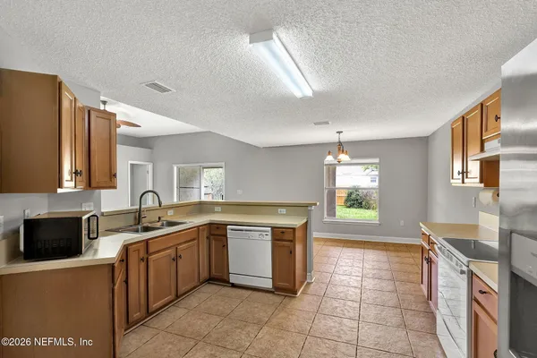 a kitchen with a sink stove and cabinets