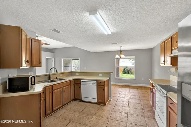 a kitchen with a sink stove and cabinets