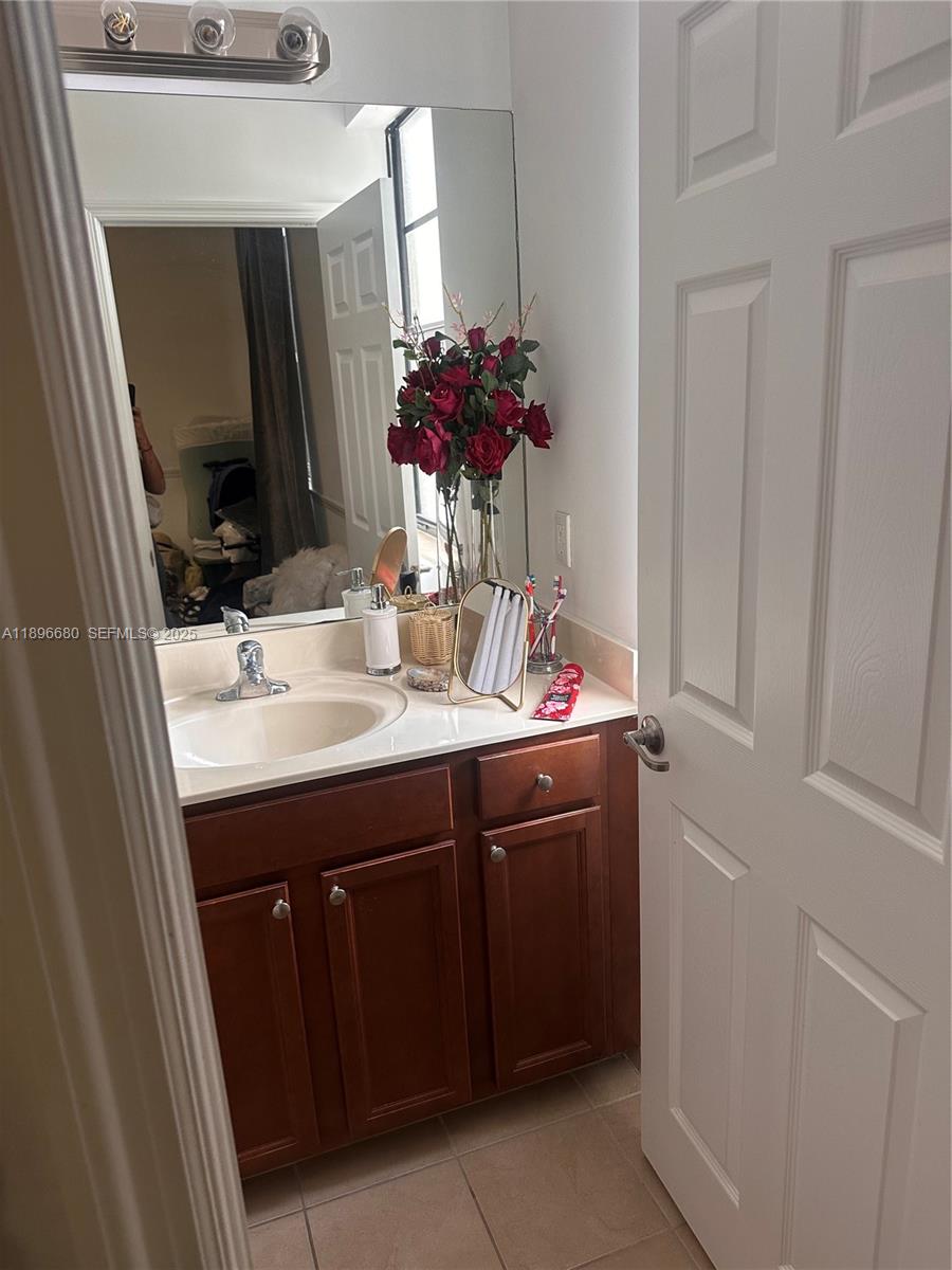 8867 West 35th Way Hialeah, FL 33018 - Photo 14 of 15 a bathroom with a sink and a mirror