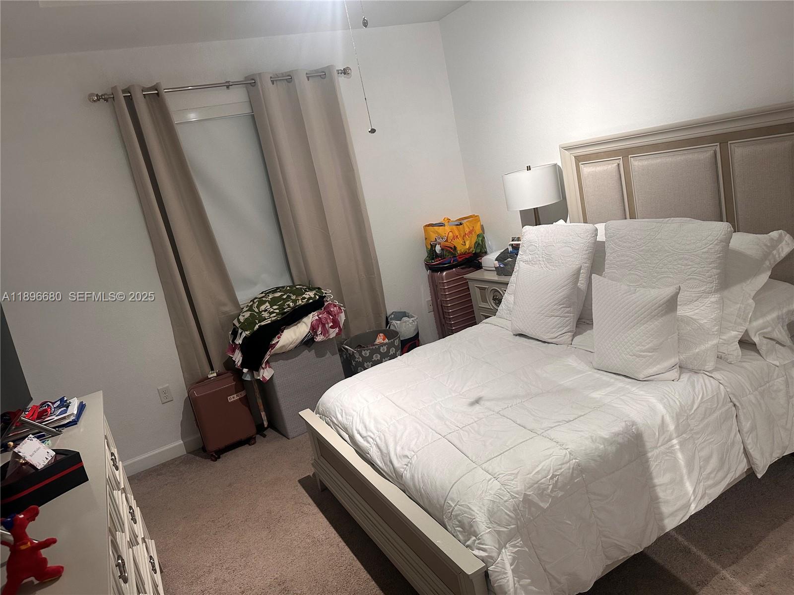 8867 West 35th Way Hialeah, FL 33018 - Photo 8 of 15 a bedroom with a bed and a window