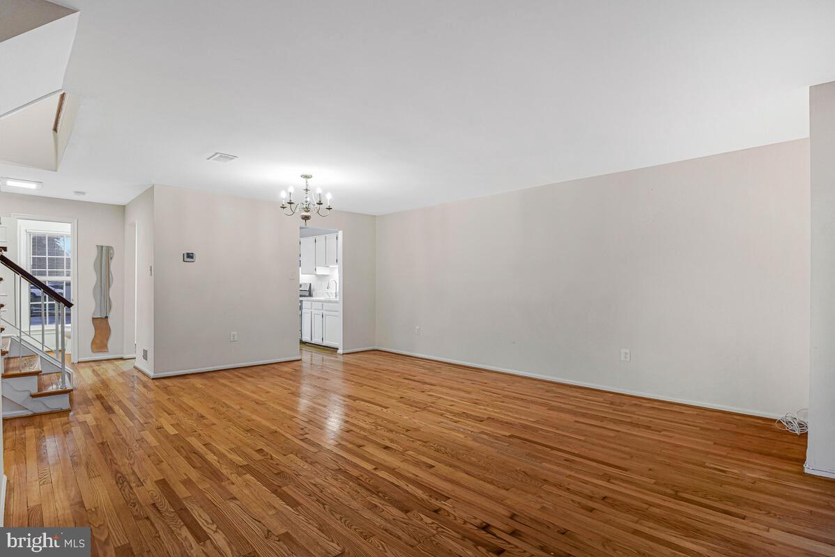 7865 Parthian Court Springfield, VA 22153 - Photo 14 of 40 a view of an empty room with wooden floor and a window