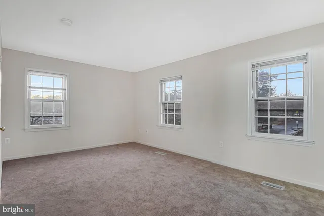 a view of a livingroom with wooden floor and a fireplace