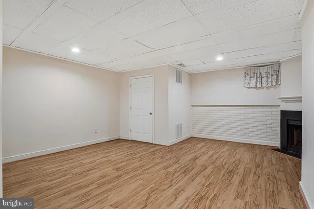 a side view of a house with a wooden fence