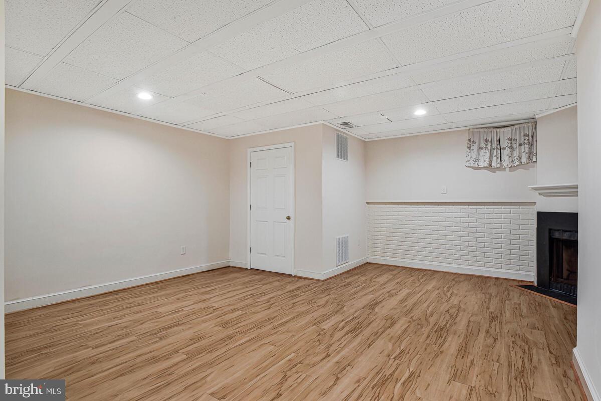 7865 Parthian Court Springfield, VA 22153 - Photo 24 of 40 a view of an empty room with wooden floor