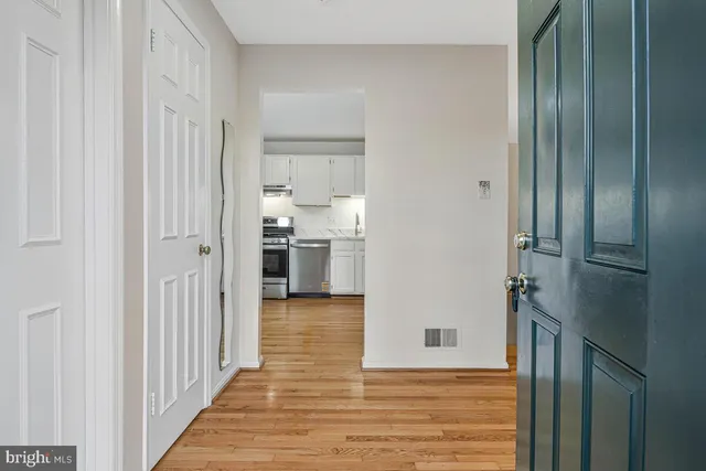 a kitchen with granite countertop white cabinets and stainless steel appliances