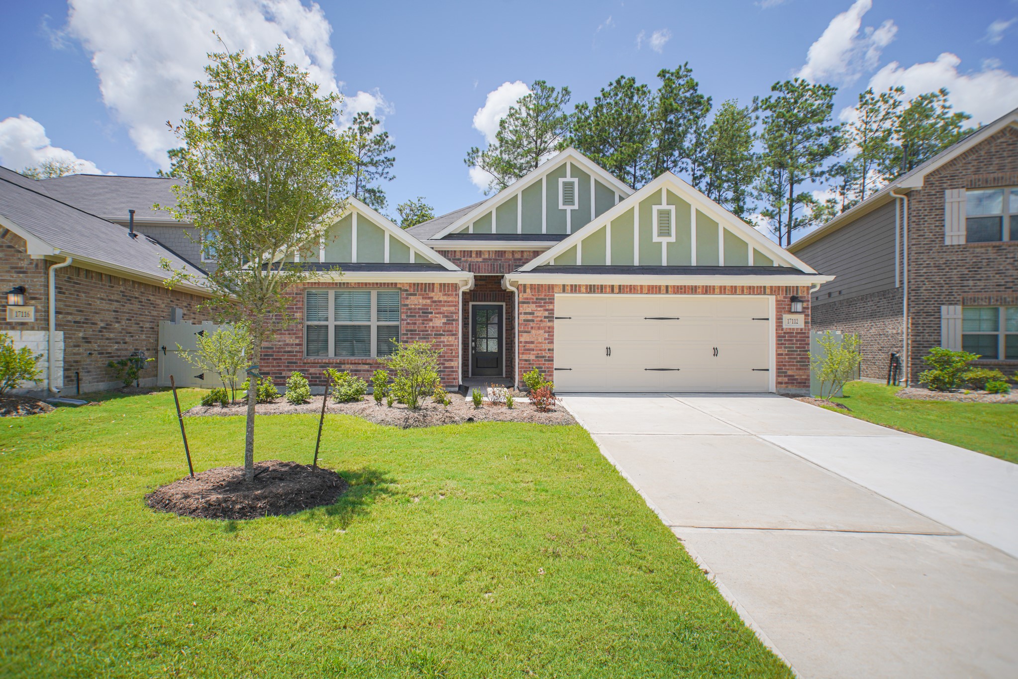 17112 Coneflower Place Conroe, TX 77385 - Photo 1 of 27 a front view of a house with a yard and garage
