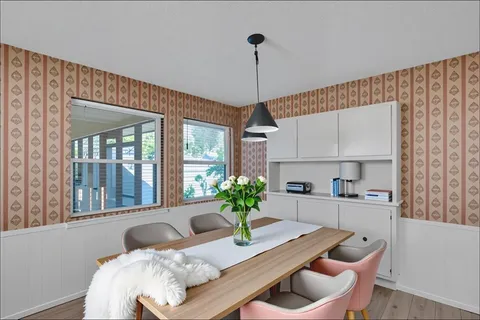 a dining room with furniture and window
