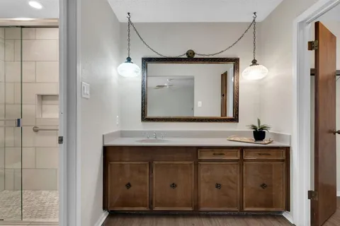 a bathroom with a sink vanity and a mirror