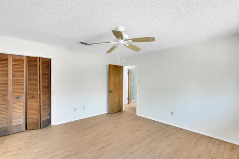 a view of a room with a ceiling fan