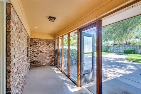 a view of entryway with wooden floor and fence