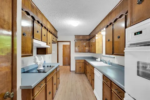a bathroom with a granite countertop double vanity sink and mirror