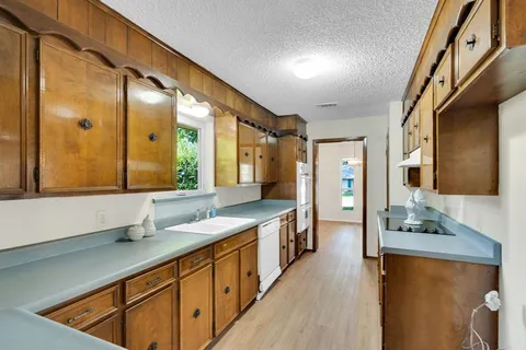 a bathroom with a sink a mirror and shower