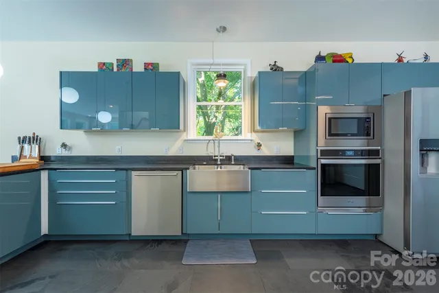 a kitchen with cabinets and window