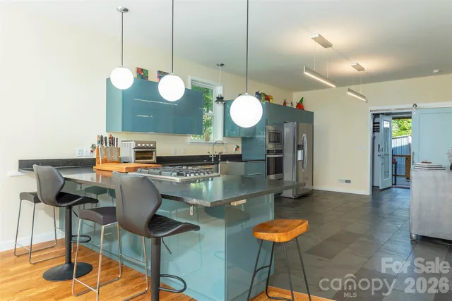 a kitchen with a table and chairs